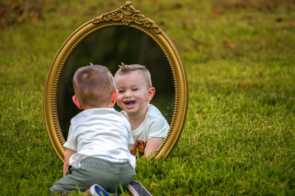 little boy seeing the mirror with happy face 