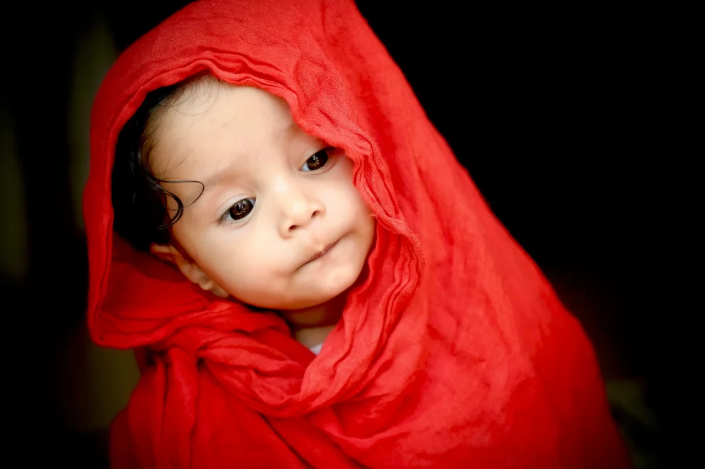 baby girl wearing red scarf