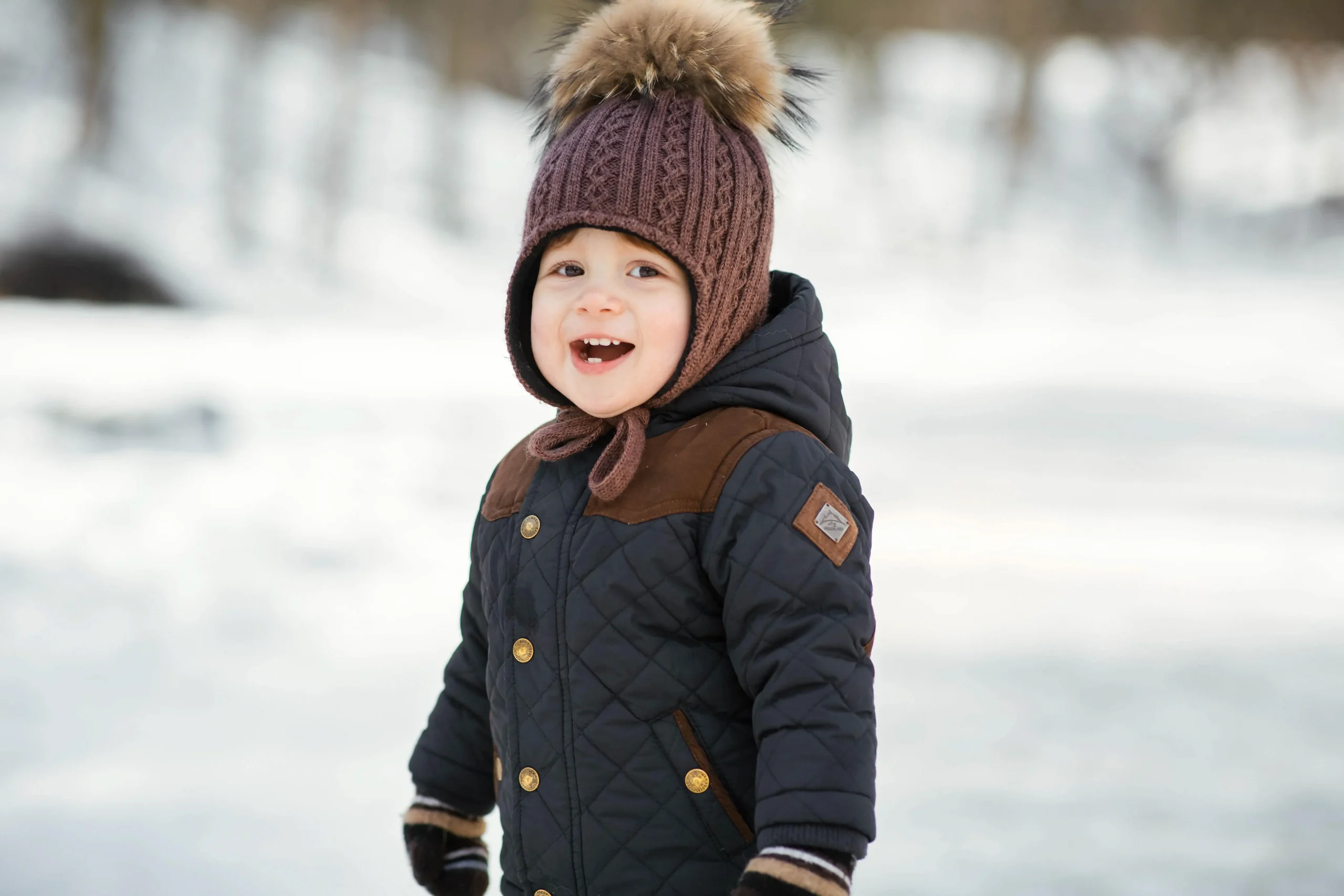 charming little boy smiling in winter