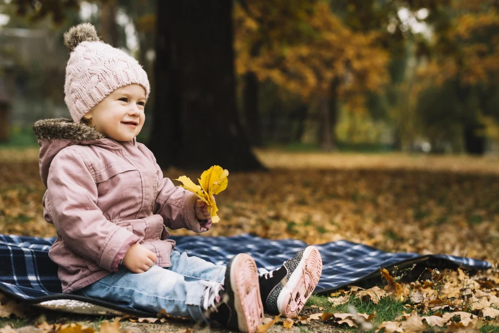 cheerful girl sitting in woods autumn