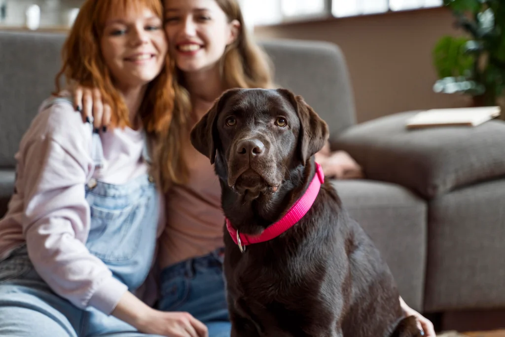 women posing with black dog