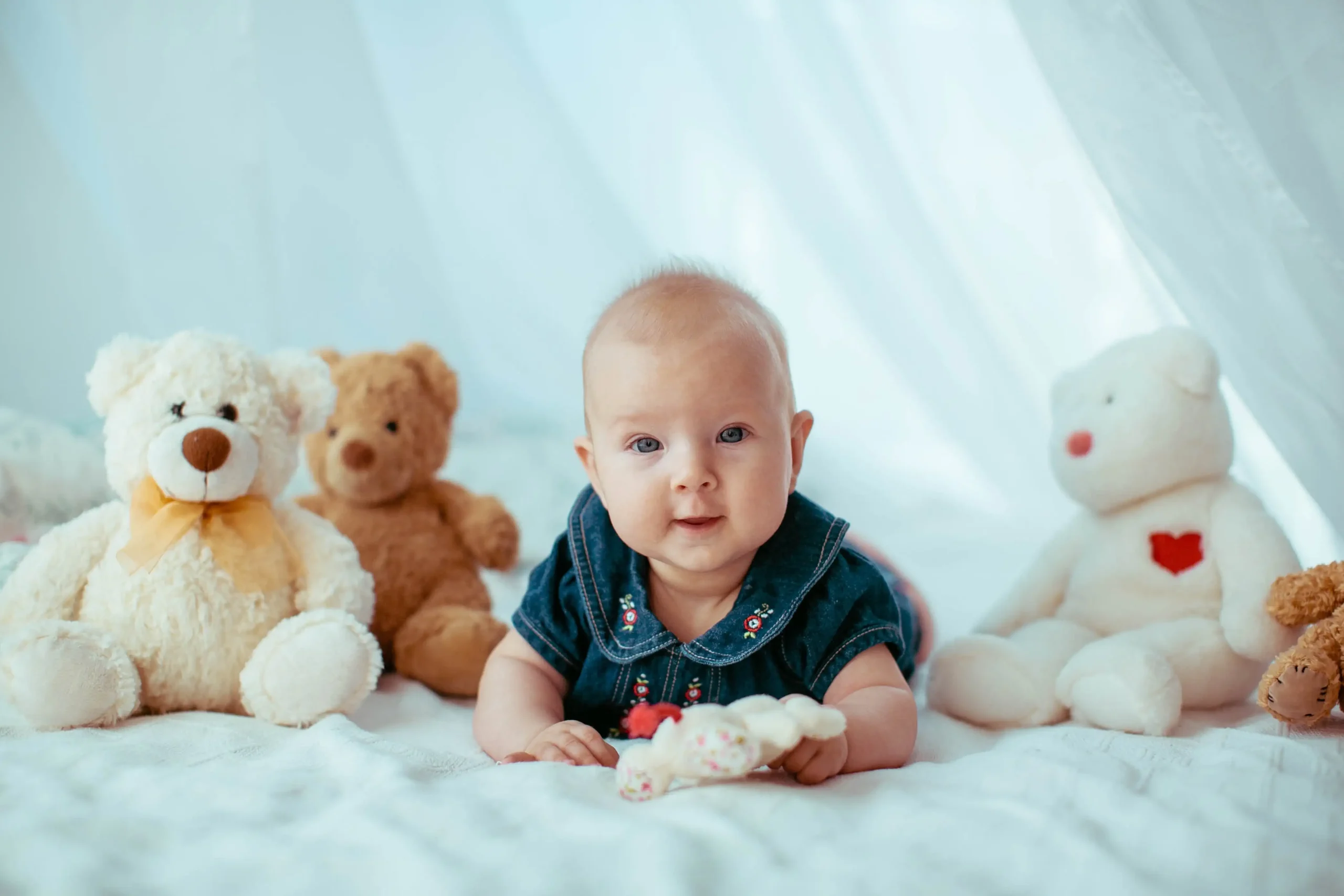 cute baby boy on bed with teddy bears closeup shot
