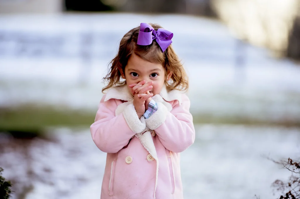 little girl praying outside in winter