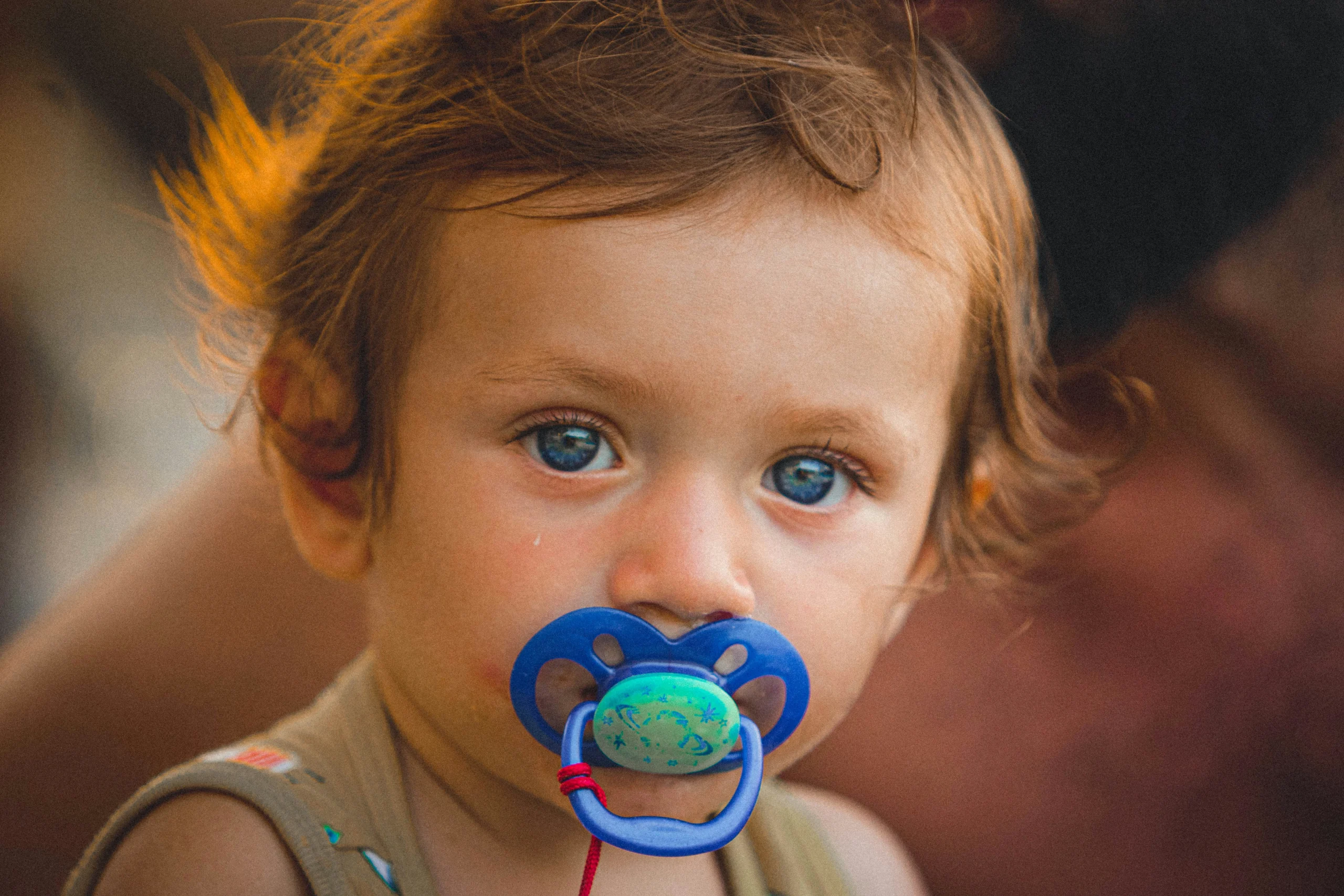 beautiful baby with soother in mouth
